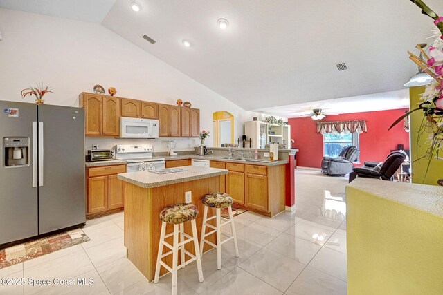 427 Falls Church St SW, Palm Bay, FL 32908 - kitchen with white appliances, open floor plan, ceiling fan, a peninsula, and a breakfast bar