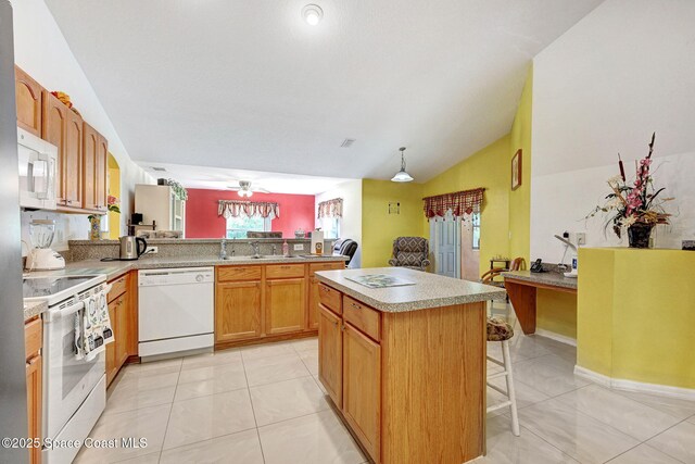 427 Falls Church St SW, Palm Bay, FL 32908 - kitchen with white appliances, a sink, a peninsula, lofted ceiling, and a kitchen bar