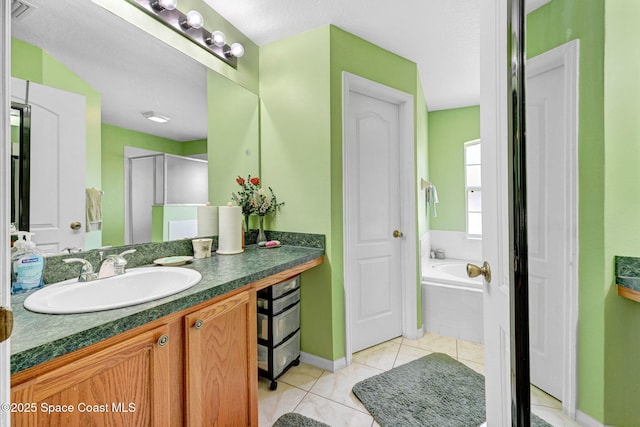 427 Falls Church St SW, Palm Bay, FL 32908 - full bath featuring vanity, baseboards, tile patterned floors, and a garden tub