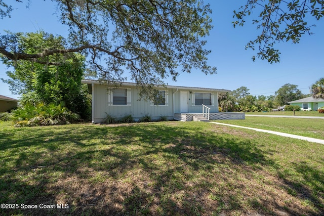 4545 Tina St, Cocoa, FL 32927 - ranch-style house with board and batten siding and a front lawn