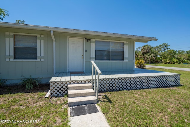 4545 Tina St, Cocoa, FL 32927 - property entrance featuring a yard and board and batten siding