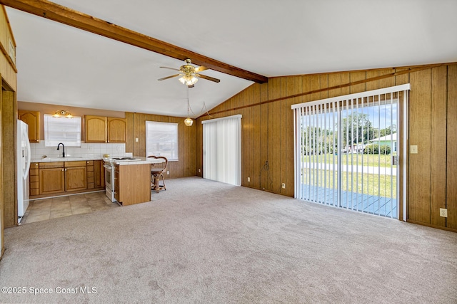 4545 Tina St, Cocoa, FL 32927 - kitchen with electric stove, light countertops, ceiling fan, healthy amount of natural light, and wood walls