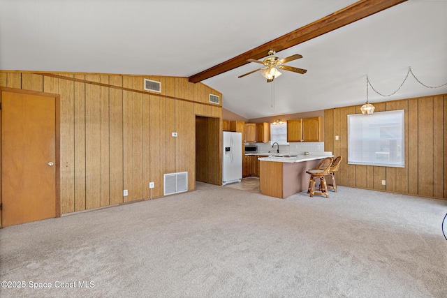 4545 Tina St, Cocoa, FL 32927 - kitchen with white refrigerator with ice dispenser, a ceiling fan, a peninsula, stainless steel microwave, and light countertops