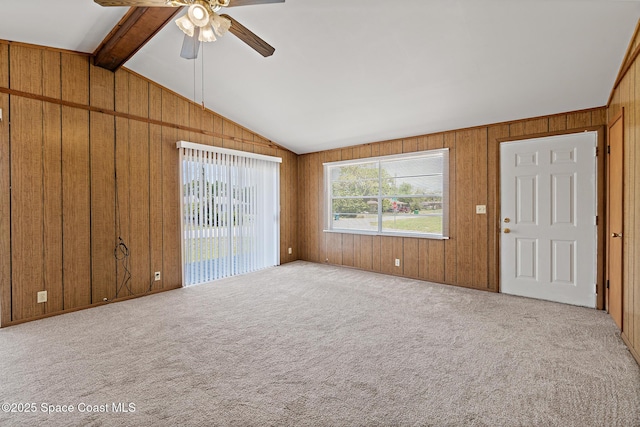 4545 Tina St, Cocoa, FL 32927 - unfurnished living room featuring a ceiling fan, wooden walls, and carpet