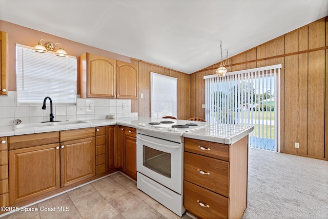 4545 Tina St, Cocoa, FL 32927 - kitchen featuring white electric range oven, a peninsula, lofted ceiling, plenty of natural light, and wooden walls