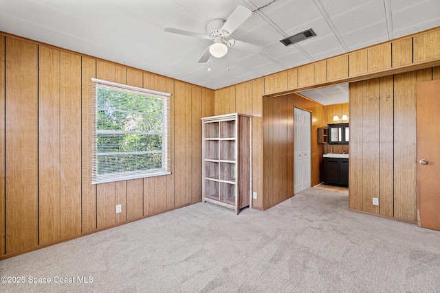 4545 Tina St, Cocoa, FL 32927 - carpeted empty room featuring wood walls and ceiling fan