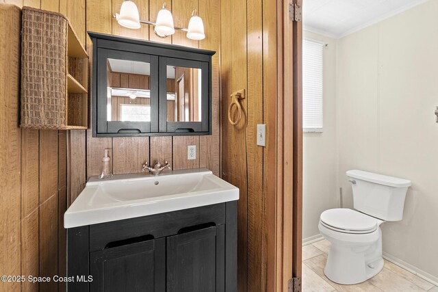 4545 Tina St, Cocoa, FL 32927 - bathroom with toilet, ornamental molding, plenty of natural light, vanity, and baseboards