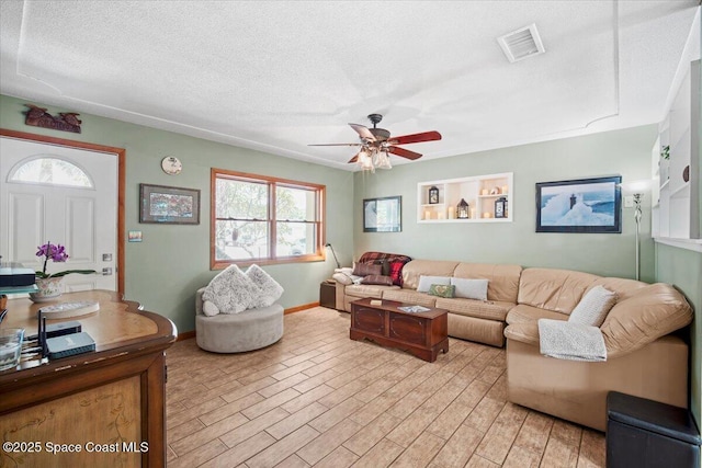 1225 Colby Ln, Merritt Island, FL 32952 - living room with ceiling fan, baseboards, and a textured ceiling