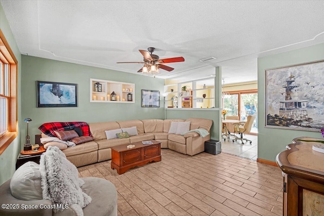 1225 Colby Ln, Merritt Island, FL 32952 - living area featuring a ceiling fan and a textured ceiling