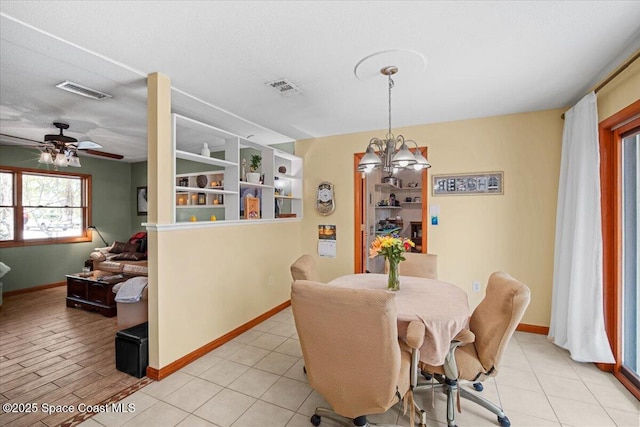 1225 Colby Ln, Merritt Island, FL 32952 - dining area with a chandelier, baseboards, and a ceiling fan