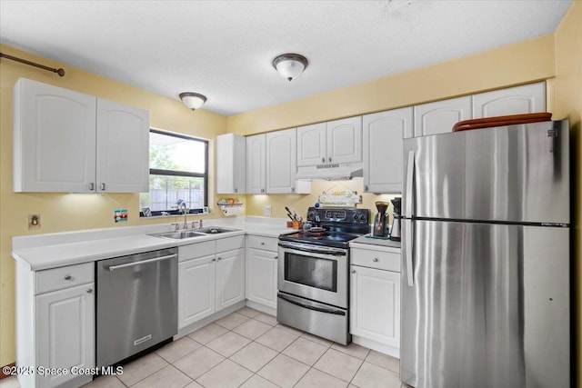1225 Colby Ln, Merritt Island, FL 32952 - kitchen with appliances with stainless steel finishes, under cabinet range hood, a sink, white cabinetry, and a textured ceiling
