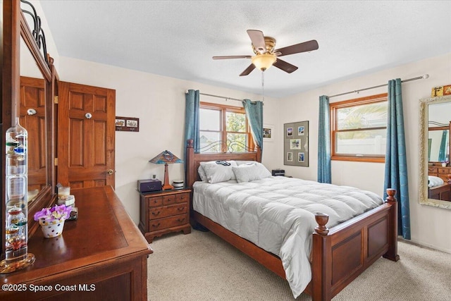 1225 Colby Ln, Merritt Island, FL 32952 - bedroom with light colored carpet, a ceiling fan, and a textured ceiling