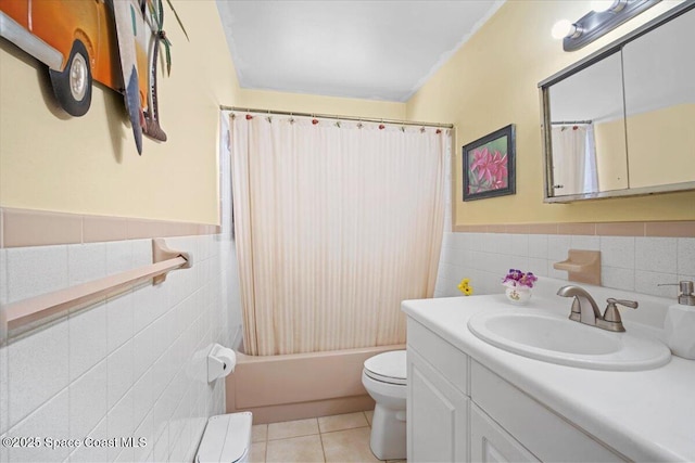 1225 Colby Ln, Merritt Island, FL 32952 - bathroom featuring tile walls, toilet, tile patterned floors, vanity, and shower / bath combo with shower curtain