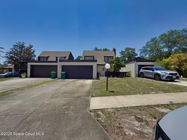 3454 Pheasant Ct, Melbourne, FL 32935 - view of front facade with an attached garage, concrete driveway, stucco siding, a front yard, and a chimney