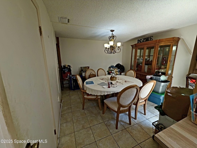 3454 Pheasant Ct, Melbourne, FL 32935 - dining room with a chandelier, tile patterned flooring, and a textured ceiling