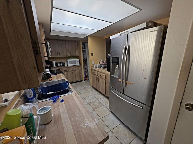3454 Pheasant Ct, Melbourne, FL 32935 - kitchen with stainless steel appliances, light tile patterned floors, and light countertops