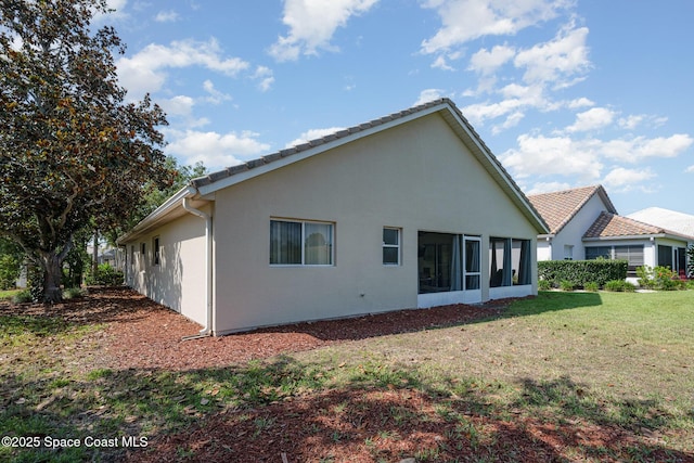 8002 Bradwick Way, Melbourne, FL 32940 - rear view of house with a yard, stucco siding, and a sunroom
