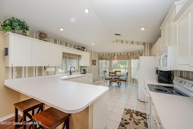 8002 Bradwick Way, Melbourne, FL 32940 - kitchen featuring white appliances, a breakfast bar, light countertops, a sink, and recessed lighting