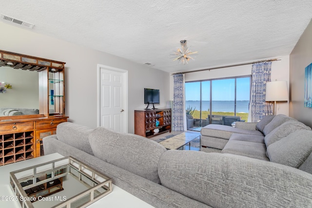 2880 S Atlantic Ave Unit 102, Cocoa Beach, FL 32931 - living room with a textured ceiling