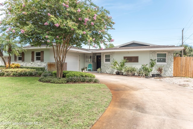 3511 Constitution Dr, Titusville, FL 32780 - ranch-style house with stone siding, an attached garage, concrete driveway, and stucco siding