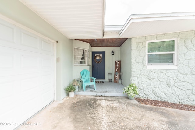 3511 Constitution Dr, Titusville, FL 32780 - property entrance featuring a porch, an attached garage, and stucco siding