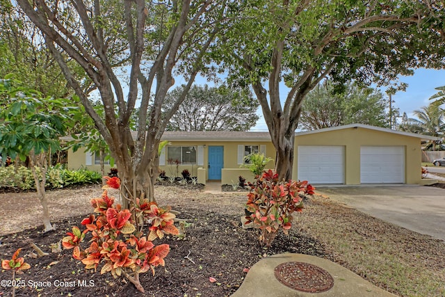 ranch-style house featuring stucco siding, concrete driveway, and a garage