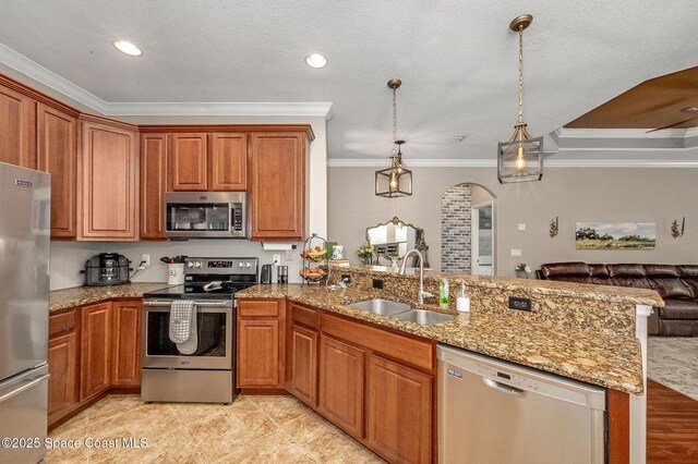 1409 Corbett Ln, Melbourne, FL 32904 - kitchen with appliances with stainless steel finishes, a sink, ornamental molding, open floor plan, and a peninsula