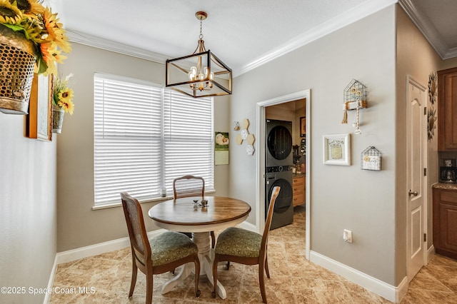1409 Corbett Ln, Melbourne, FL 32904 - dining room featuring estacked washer and dryer, ornamental molding, a chandelier, healthy amount of natural light, and baseboards