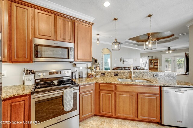 1409 Corbett Ln, Melbourne, FL 32904 - kitchen featuring appliances with stainless steel finishes, a sink, a ceiling fan, ornamental molding, and a tray ceiling