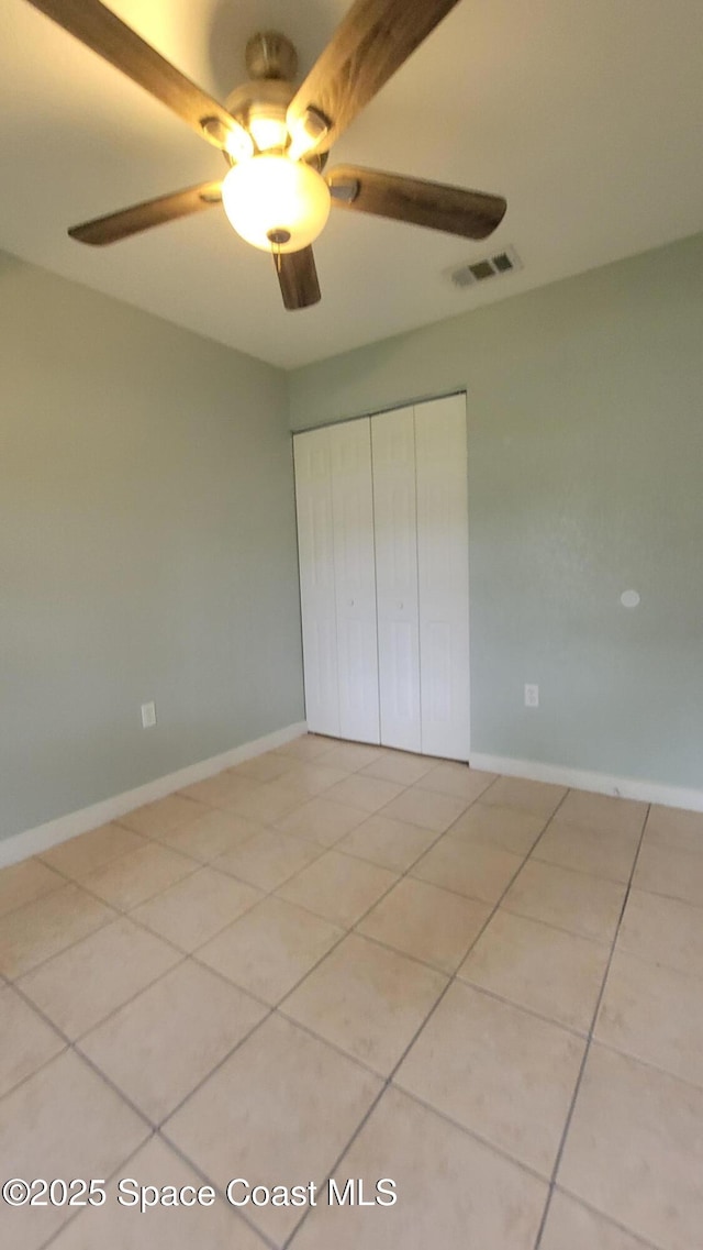 333 Galena St SW, Palm Bay, FL 32908 - unfurnished bedroom with light tile patterned floors, a closet, ceiling fan, and baseboards