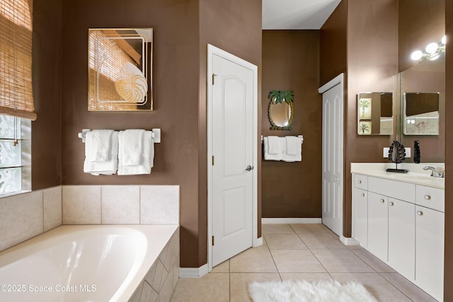 448 Birchington Ln, Melbourne, FL 32940 - full bathroom with vanity, a garden tub, tile patterned floors, baseboards, and a closet