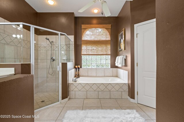 448 Birchington Ln, Melbourne, FL 32940 - bathroom with tile patterned flooring, a bath, a stall shower, and a ceiling fan
