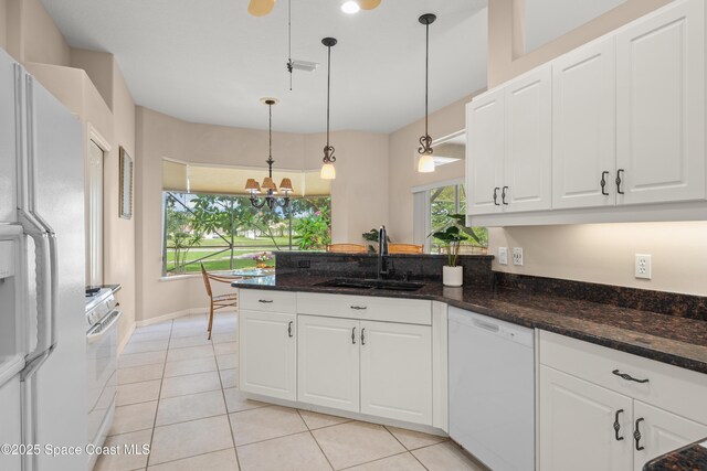 448 Birchington Ln, Melbourne, FL 32940 - kitchen featuring white appliances, a sink, white cabinets, and a chandelier
