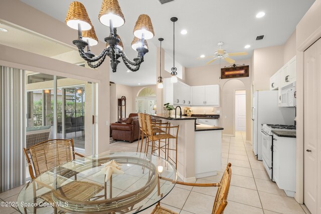 448 Birchington Ln, Melbourne, FL 32940 - dining room featuring ceiling fan, arched walkways, recessed lighting, a chandelier, and light tile patterned floors
