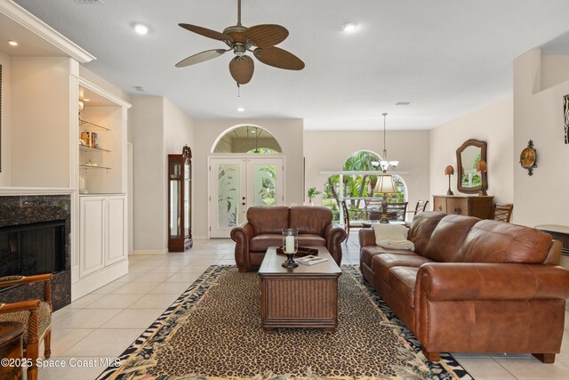 448 Birchington Ln, Melbourne, FL 32940 - living room with a ceiling fan, light tile patterned floors, recessed lighting, and a fireplace