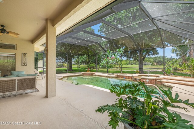 448 Birchington Ln, Melbourne, FL 32940 - view of swimming pool featuring a patio, ceiling fan, a pool with connected hot tub, and glass enclosure