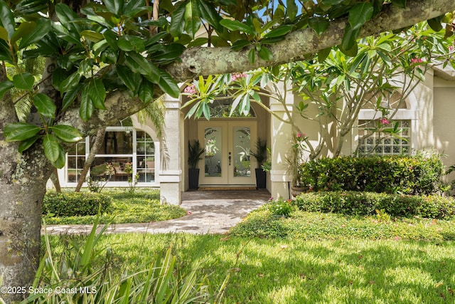 448 Birchington Ln, Melbourne, FL 32940 - doorway to property featuring french doors and stucco siding