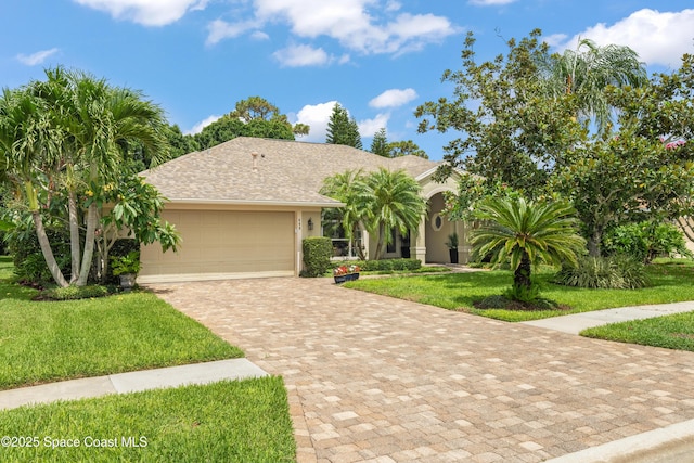 448 Birchington Ln, Melbourne, FL 32940 - view of front facade with a front lawn, an attached garage, decorative driveway, and stucco siding