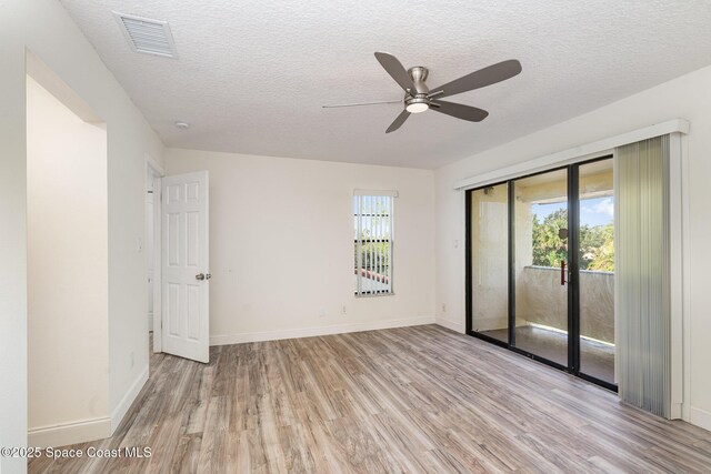 3444 Partridge Ct, Melbourne, FL 32935 - unfurnished room with light wood-style flooring, plenty of natural light, a ceiling fan, a textured ceiling, and baseboards