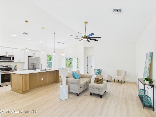 8116 97th Ct, Vero Beach, FL 32967 - living room featuring light wood-style floors, ceiling fan, recessed lighting, high vaulted ceiling, and baseboards