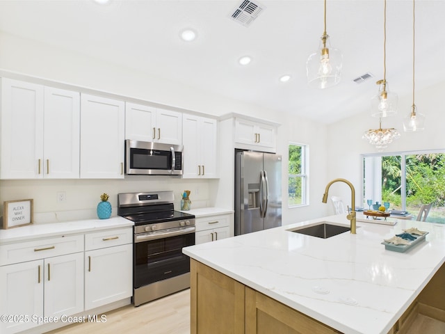 8116 97th Ct, Vero Beach, FL 32967 - kitchen featuring appliances with stainless steel finishes, a sink, a center island with sink, white cabinetry, and recessed lighting