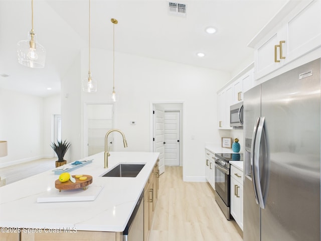 8116 97th Ct, Vero Beach, FL 32967 - kitchen with appliances with stainless steel finishes, a sink, light wood-style floors, white cabinets, and recessed lighting