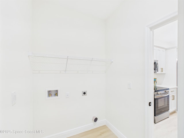 8116 97th Ct, Vero Beach, FL 32967 - washroom featuring electric dryer hookup, washer hookup, baseboards, and light wood-type flooring