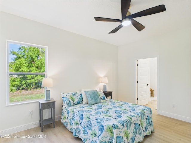 8116 97th Ct, Vero Beach, FL 32967 - bedroom with light wood-style flooring, baseboards, ensuite bathroom, and ceiling fan