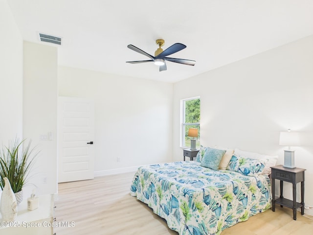 8116 97th Ct, Vero Beach, FL 32967 - bedroom featuring wood finished floors, baseboards, and a ceiling fan