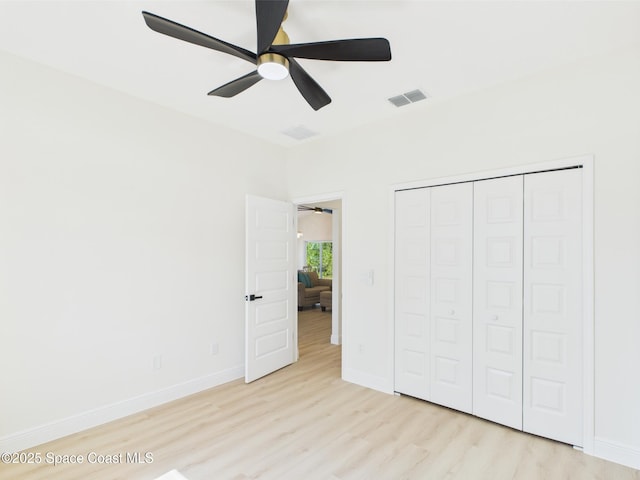 8116 97th Ct, Vero Beach, FL 32967 - unfurnished bedroom featuring wood finished floors, baseboards, a closet, and a ceiling fan