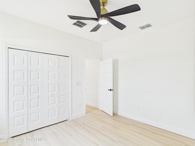 8116 97th Ct, Vero Beach, FL 32967 - unfurnished bedroom with wood finished floors, a closet, baseboards, and a ceiling fan