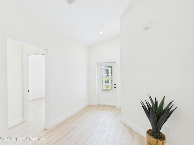8116 97th Ct, Vero Beach, FL 32967 - spare room featuring light wood finished floors, baseboards, lofted ceiling, and recessed lighting
