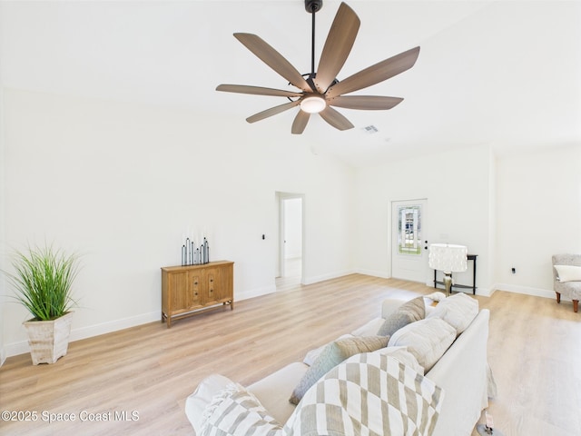 8126 97th Ave, Vero Beach, FL 32967 - living room with ceiling fan, light wood finished floors, vaulted ceiling, and baseboards