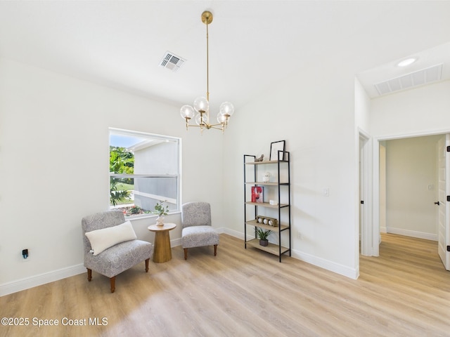 8126 97th Ave, Vero Beach, FL 32967 - living area featuring light wood-style floors, a chandelier, and baseboards